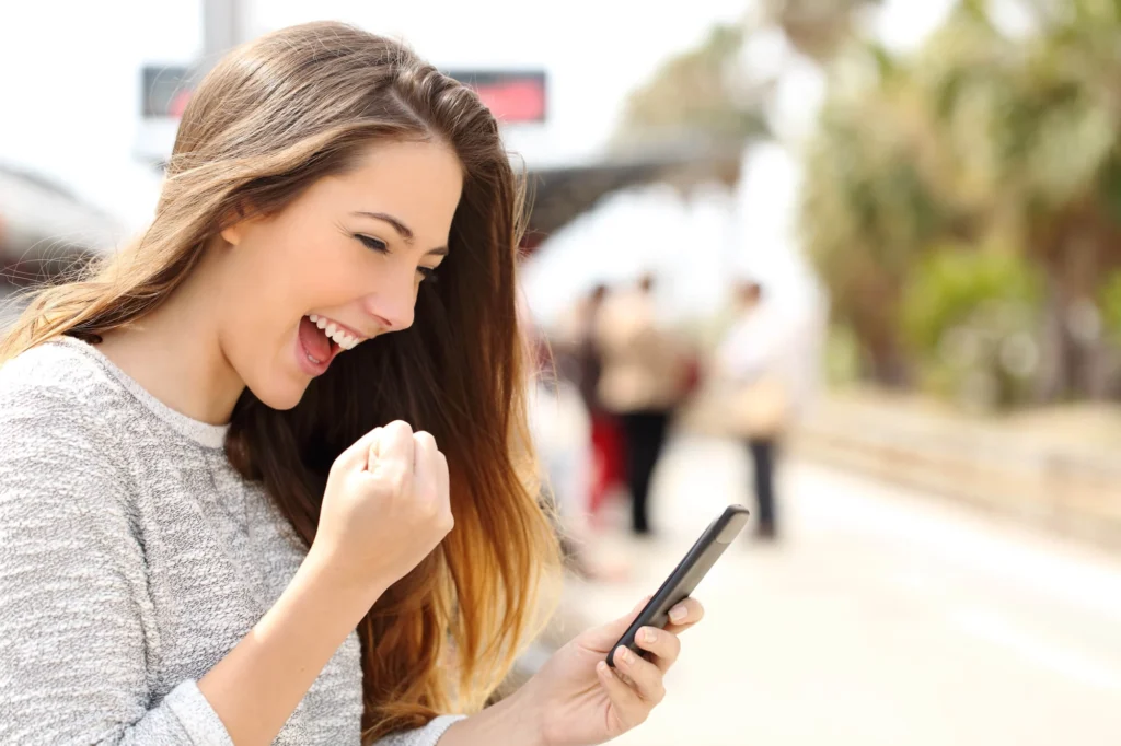 happy woman playing mobile game after seeing app install campaigns