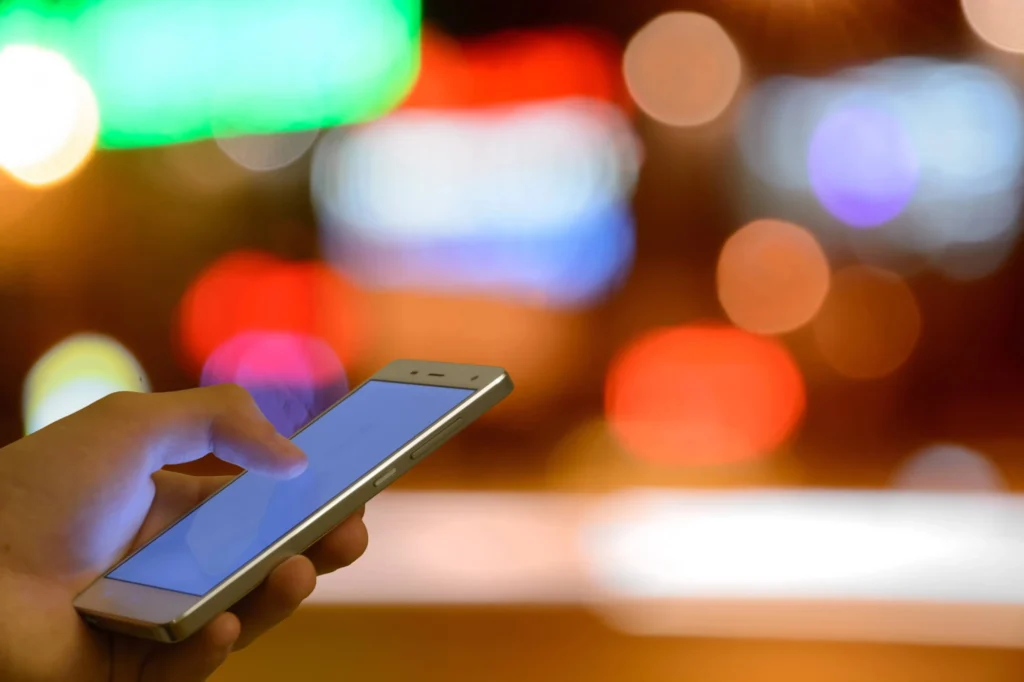 person with phone using programmatic advertising platforms