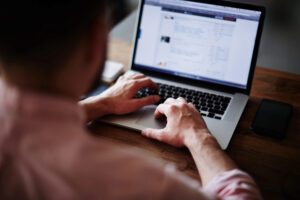 man using computer while setting automated ad buying