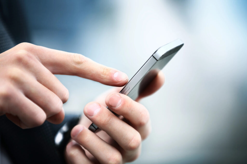 person using phone and setting programmatic advertising