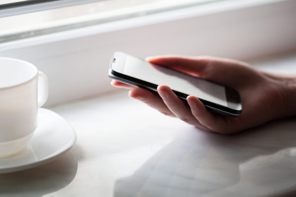 person with phone designing app marketing strategies